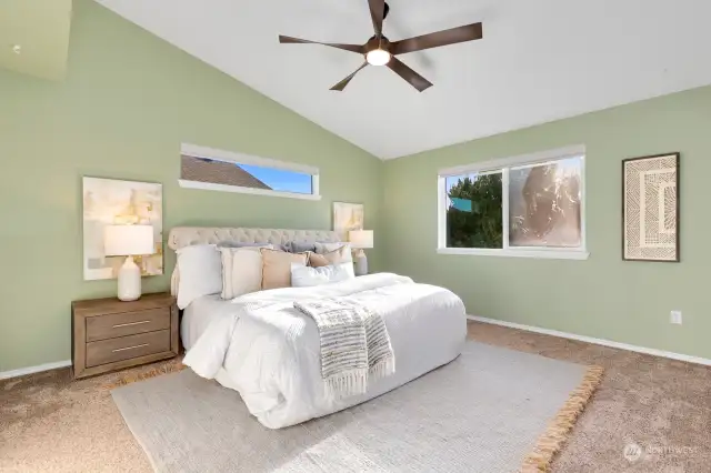 Primary room with vaulted ceilings & tons of natural light