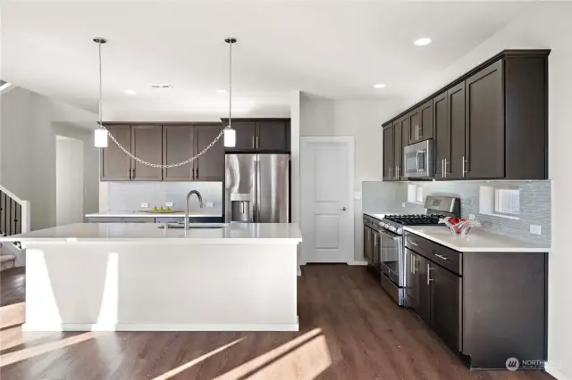 Kitchen with stainless steel appliances and walk-in pantry