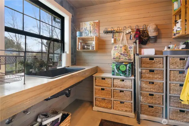 Mud room off kitchen with extra sink, fridge, and storage