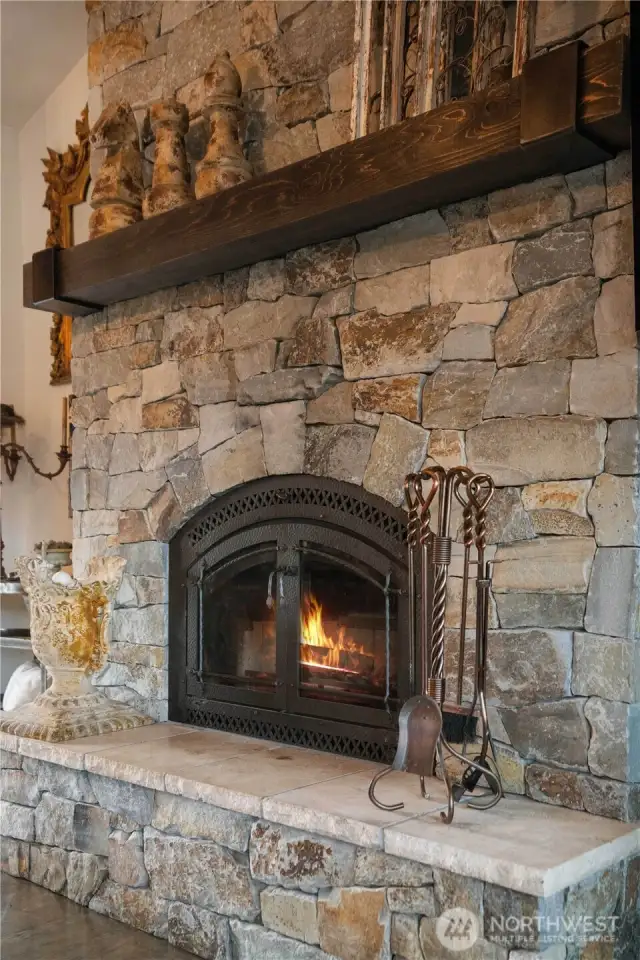 Cozy wood burning fireplace adding to the warmth of the family room