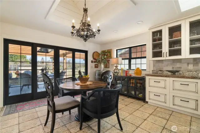 large breakfast area with access to back patio on one side of the kitchen