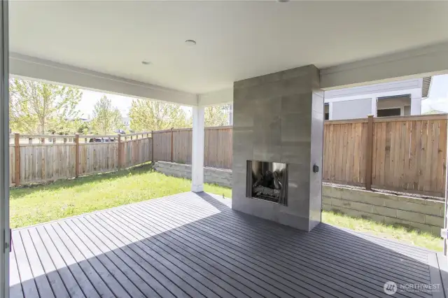 Signature Outdoor Room, pre-wired for ceiling fan, features full-height-tiled gas fireplace