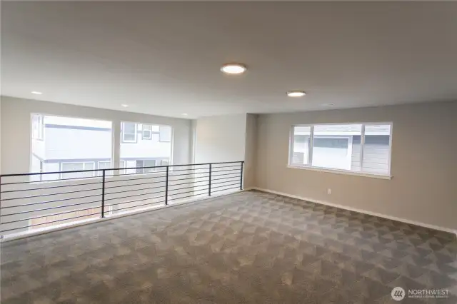 Expansive Leisure Room/Loft, facing wall-sized windows, is the perfect space for entertainment.