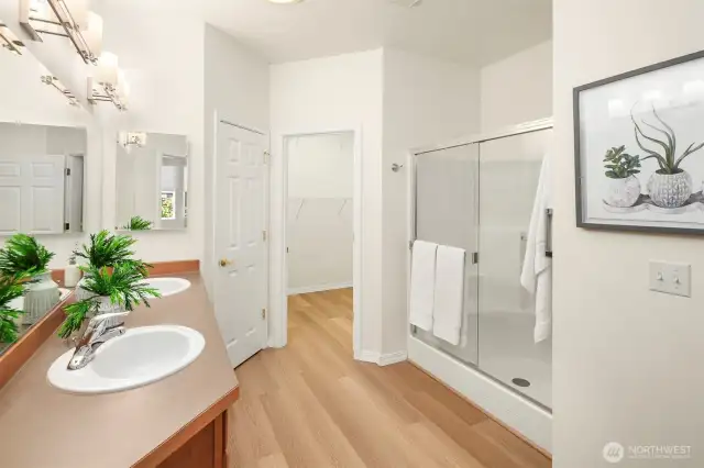 Primary bathroom includes a spacious walk-in closet, linen closet, updated lighting, chair-height Kohler toilet, dual sink sinks, luxury vinyl plank flooring and 2 solar tubes for gorgeous natural light.