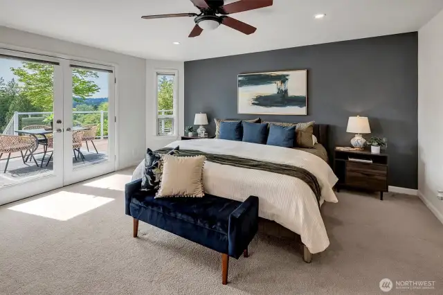 Lavish primary suite with french doors leading to the massive deck and hot tub
