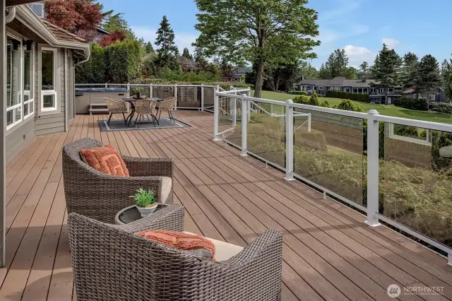 Sun drenched  entertainment sized low maintenance composite deck overlooking the 4th hole and green