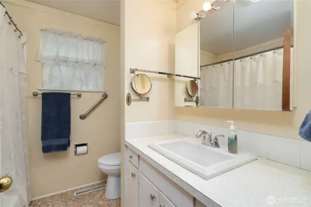 Full bathroom with some bars for safety