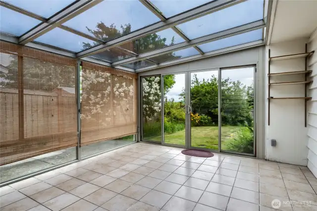 The sun room, for getting warm and enjoying extra light.  enough room to entertain.  can be used for growing plants or as an art studio, or for pets, or yoga or massage.   Use your imagination.