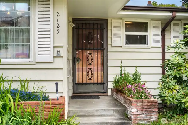 built-in planters, strong hand rail up the stairs, covered entry.