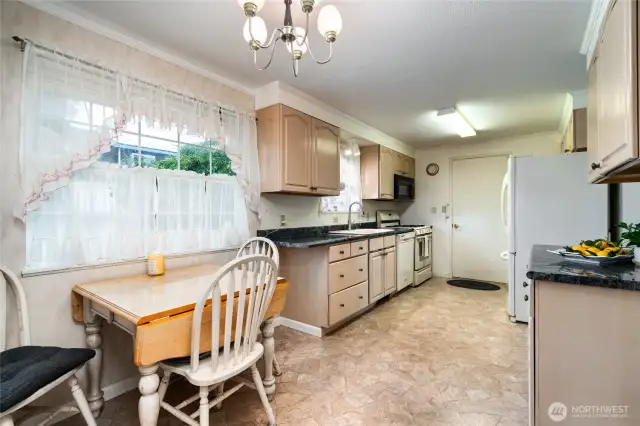 eating space in the kitchen with view to H. Ave.  garage access into the kitchen, and dining room is to the left.