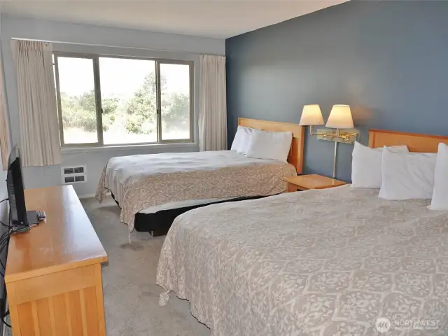 Spacious Bedroom w/ 2 Queen-sized beds.