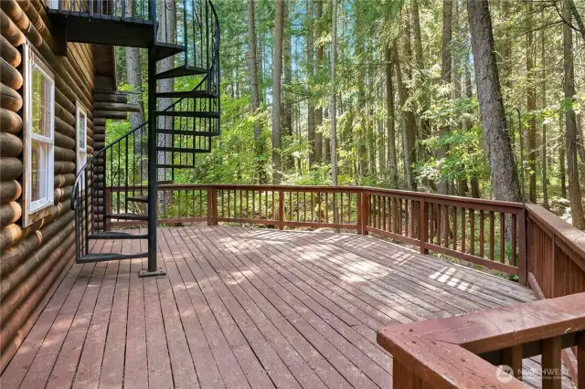 Spacious deck off kitchen area. Spiral staircase leads up to master bedroom area on upper level