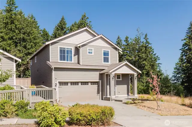 Front exterior showcasing lush landscaping and inviting entryway.