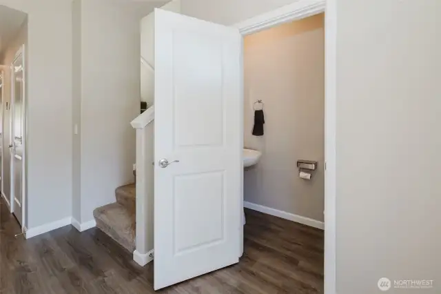 Hallway leading to convenient main-level powder room.