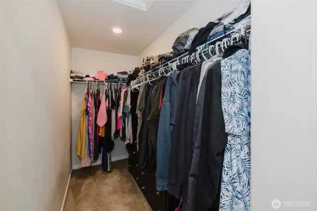 Expansive walk-in closet with built-in shelving.