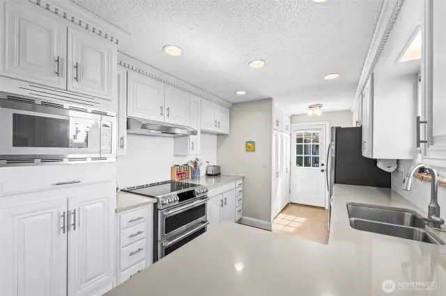 Kitchen with quartz counters and stainless appliances