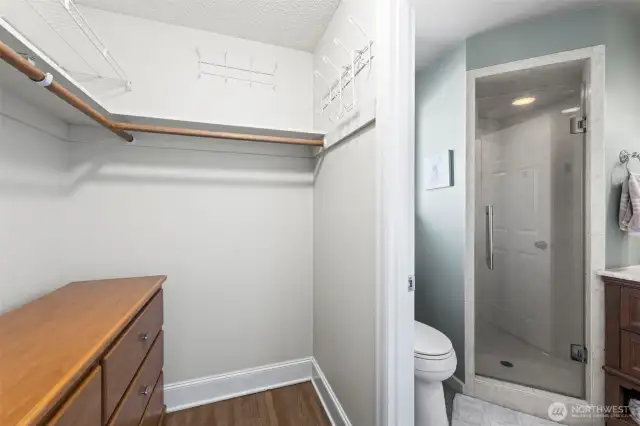 Walk in closet with three quarter bath visible