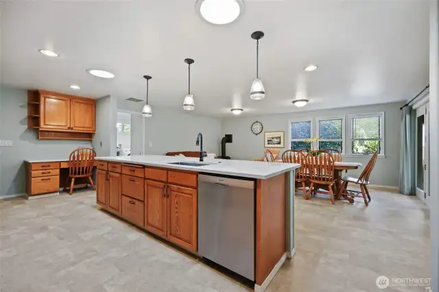 The glorious kitchen and great room are where life takes place! The extended quartz island/bar and terrific lighting in this space bring everyone together.
