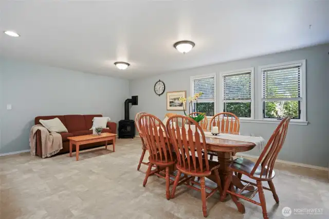 Configured simply at the moment, there is room for the whole gang with the addition of more seating! Gas stove in the corner is a wonderful way to increase the warmth and ambiance in this gathering space.