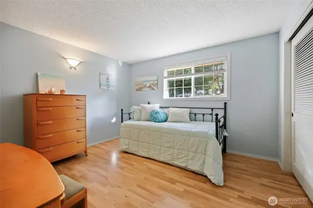 Bedroom #2 has a view of the yard and a wide closet.