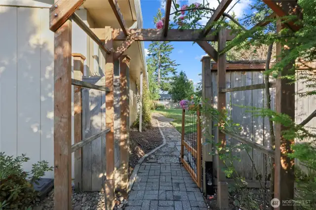 Arbor and gate from front of house to the yard makes for both beautiful and convenient access.