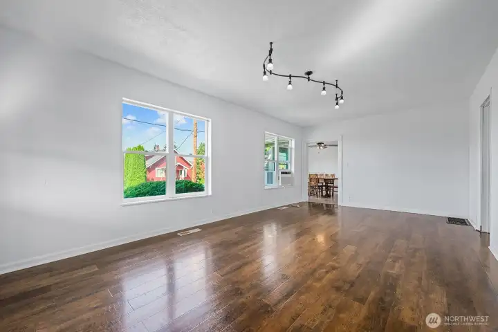 Featuring large picture windows, gleaming wood floors, and ample wall space for décor, this room serves as the heart of the home.