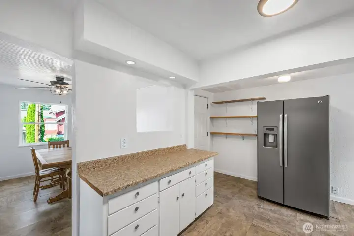 Easy-clean counters, large sink, and efficient design with sightlines into the dining area.