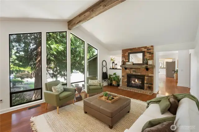 This room is the centerpiece of the home with the classic wood-burnng fireplace, a cozy gathering spot for a quiet evening at home.