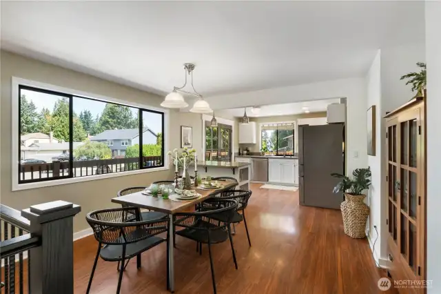 Open concept dining off of the kitchen- notice the cohesiveness of the laminate floors through the whole upper level.