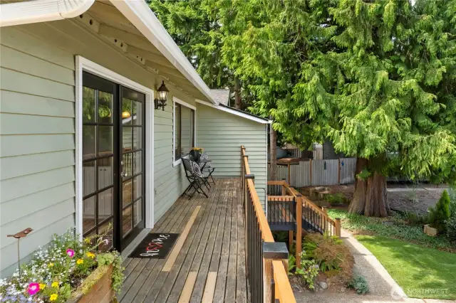 From the corner of the deck, lookiing back to the front of the house, and French doors off kitchen.  Homeowner just replaced all the spindles on the railings to update.