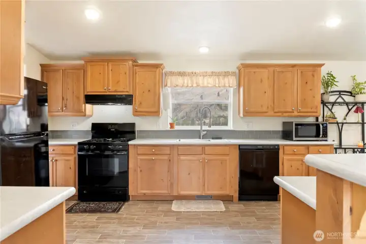 Well appointed kitchen with matching black appliances.