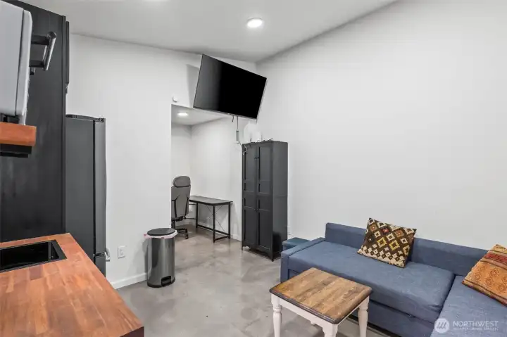 Pool room with kitchenette and concrete floors