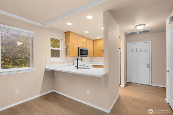Breakfast seating at kitchen, door offer direct entry to unit from garage.