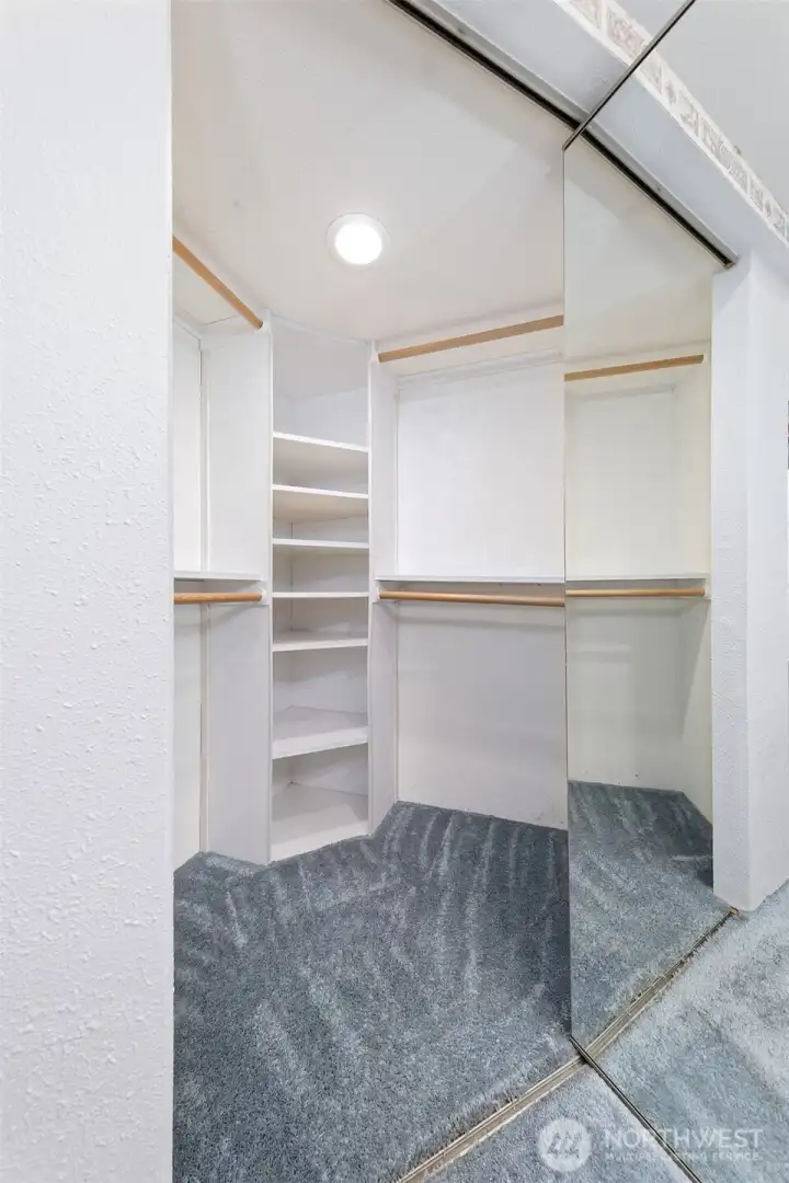 Primary bedroom closet - very roomy, with shelving.