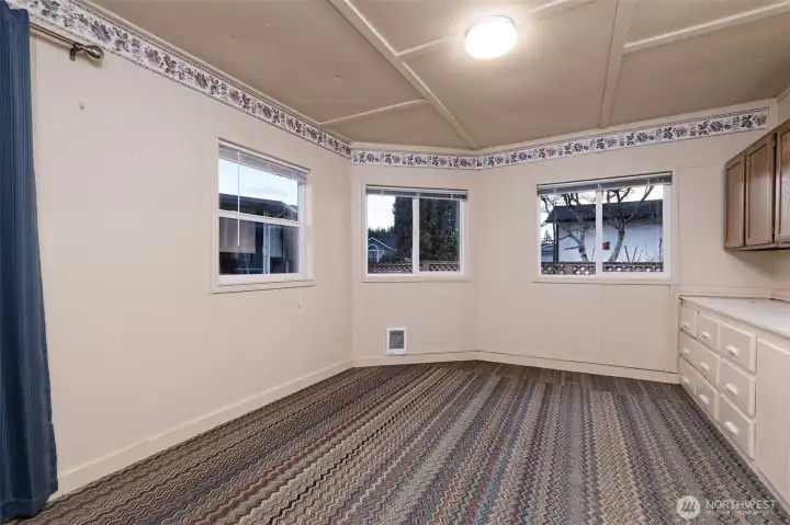 This is the hobby room behind the garage!  Great for crafts or wood-working? Private office space? Workout room?Sliding glass door on the left leads into the back yard.