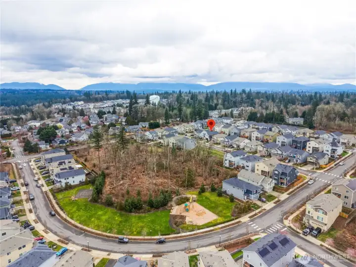 Aerial perspective of this Covington WA home for sale highlighting the surrounding neighborhood, community streets, and convenient access to shopping, parks, and commuter routes in Covington Washington.