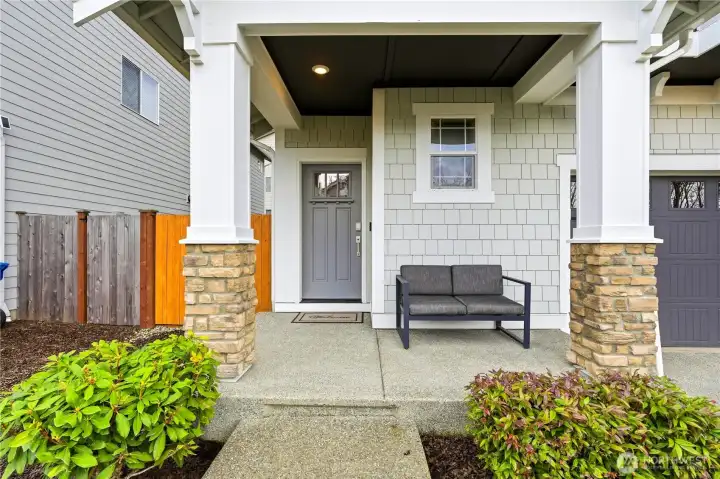Welcoming covered front entry of this Covington WA home featuring a sheltered porch, modern exterior finishes, and an inviting entryway that sets the tone for this beautifully maintained 2020 built residence.