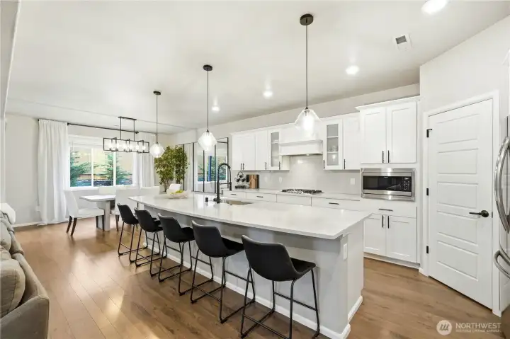 Spacious great room with gas fireplace and large windows providing natural light and comfortable living space.