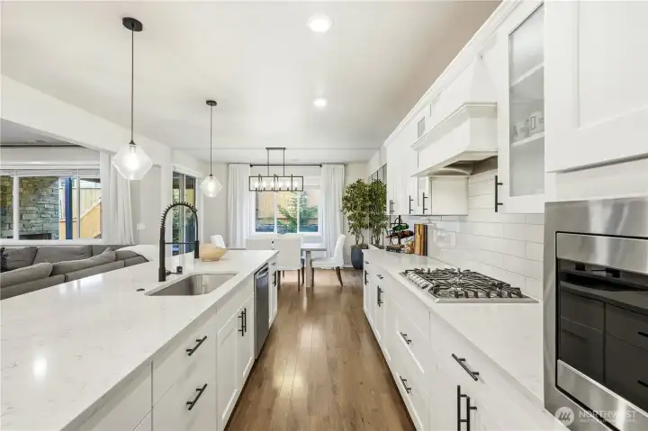 Large open concept kitchen with oversized island and walk in pantry in this Covington Washington home for sale, perfect for entertaining and everyday cooking.