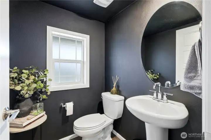 Main floor powder bathroom with modern vanity and updated fixtures in this Covington Washington home for sale located in the Kent School District.