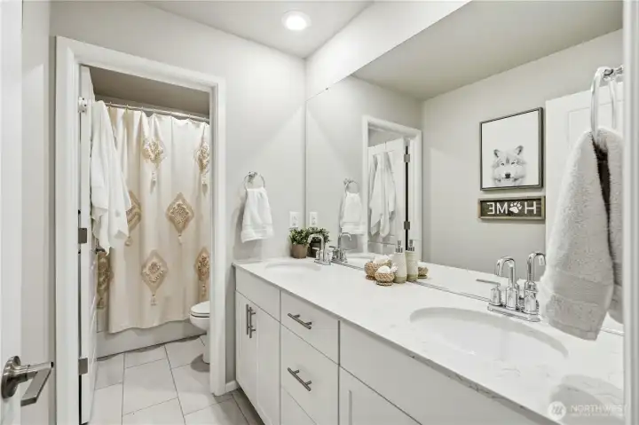Full bathroom serving additional bedrooms with clean modern finishes in this Covington WA home for sale.d