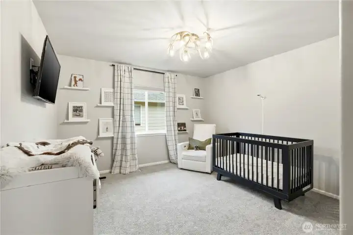 Bright additional bedroom with large window and modern finishes inside this Covington WA home for sale, offering comfortable space for guests, family members, or a home office in this Covington Washington real estate listing.