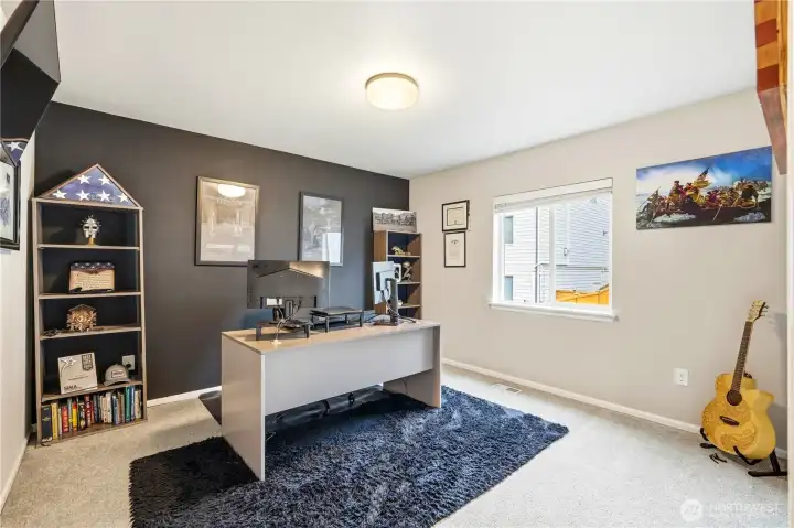 Additional upstairs bedroom or flexible living space inside this Covington WA home for sale, ideal for a home office, playroom, or guest bedroom in this spacious Covington Washington home.