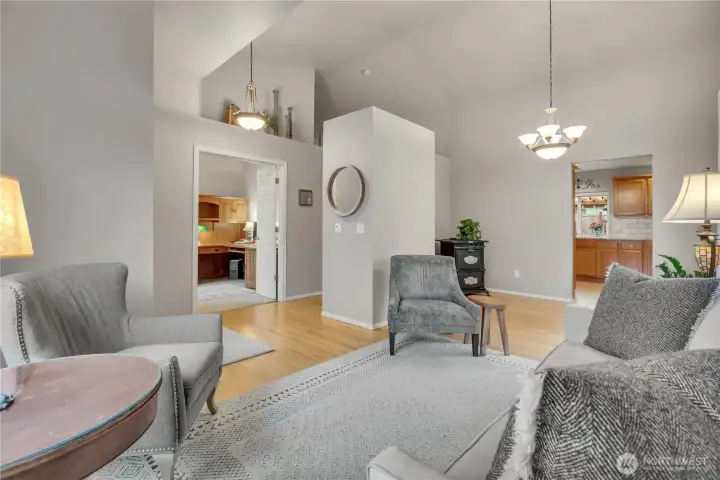 Main floor living room offers ample natural light and leads into the dining and kitchen areas.