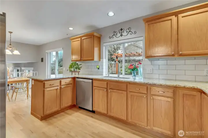 Granite counters, stainless steel appliances, and subway tile backsplash all add warmth and style to the well designed kitchen.