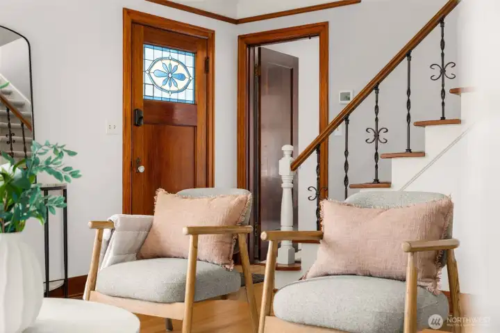 Look at the stained glass and hand wrought staircase detail! Original finishes thoughtfully maintained.