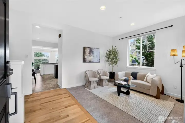 Step inside to a light-filled living space where expansive windows take full advantage of the corner-unit positioning. Fresh interior paint and brand-new carpet in 2026 give the home a clean, updated feel, while the layout offers a comfortable separation between living, working, and private spaces across two levels.
