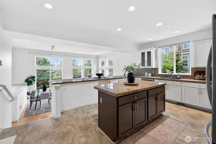 Designed for both daily living and hosting, the kitchen flows seamlessly into the dining area and out toward the deck and family room. The combination of wide sightlines, natural light, and ample prep space makes this a standout gathering space.