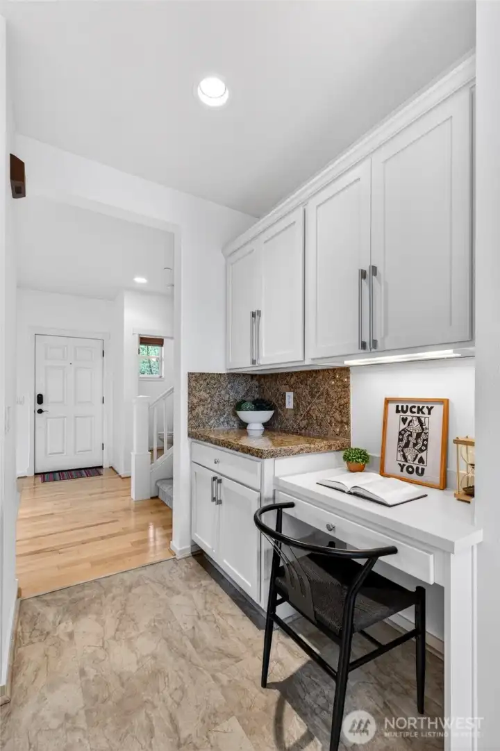 A rare and highly functional built-in nook creates a versatile space ideal for a home office, coffee station, or additional prep area. This is a unique feature not commonly found in similar homes, adding flexibility without sacrificing flow.