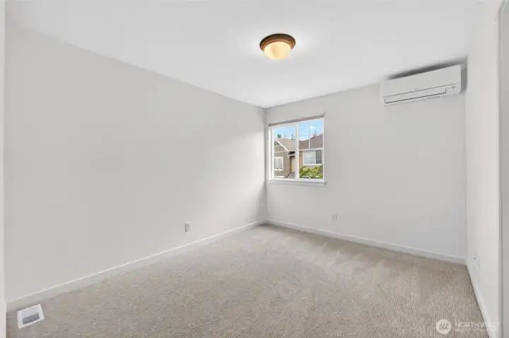 The third bedroom offers a comfortable and versatile space, ideal for guests, a home office, or additional living needs. Clean lines, natural light, and thoughtful placement near the adjoining bath make it both practical and inviting. Both bedrooms have large closets.